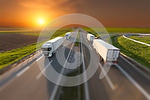 Tilt shift image of delivery trucks on the highway