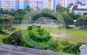 Tilt-shift lens photography miniature effect. Aerial view of neighbourhood public park in HDB heartland estate Singapore