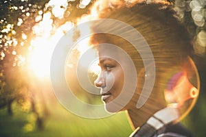 Tilt-shift portrait of black girl in front of sunset