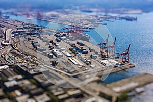 Tilt shift of shipping port with containers and loading transport ship with cargo