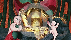 Tilt shot on golden Buddha statues in Chinese temple