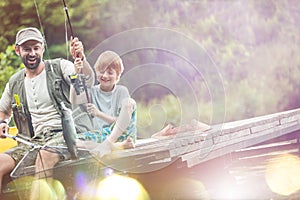 Tilt shot of happy father and son catching fish