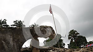 Tilt Up of Liberian or US Flag Pole Amidst Destroyed Building