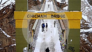 Tilt up shot of Chicham bridge with people enjoying on the bridge