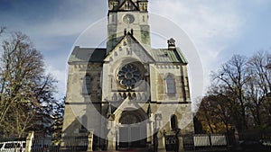 Tilt up from street and entrance of Johannes-Basilika or Basilica of St. John the Baptist in Neukoelln, Berlin to turret