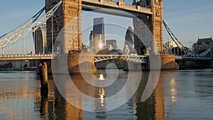 Tilt up Tower Bridge from it's reflection in the River Thames