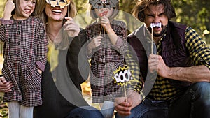 Tilt up video shows of family in Halloween masks
