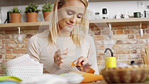 Tilt up video of woman sews in the kitchen.