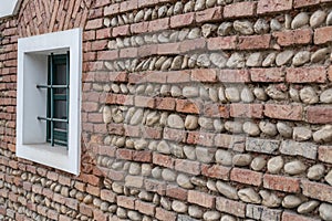 Tilt view of brick wall with old window