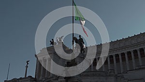 Tilt  view shows Italian flag in Vittoriano monument with  Vittorio Emanuele II equestrian bronze stautue in Rome dowtown