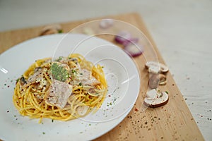 Tilted angle spaghetti carbonara with garnishes