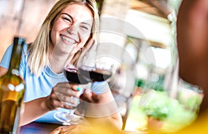 Tilted crop of happy couple toasting red wine at countryside restaurant - Food and beverage life style concept with boyfriend and