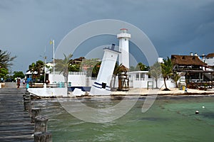 Tilted Faro Inclinado lighthouse in Puerto Morelos at the Malecon wooden pier on the Yucatan Peninsula in Mexico photo