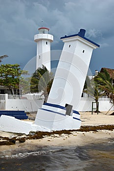 Tilted Faro Inclinado lighthouse in Puerto Morelos at the Malecon wooden pier on the Yucatan Peninsula in Mexico photo