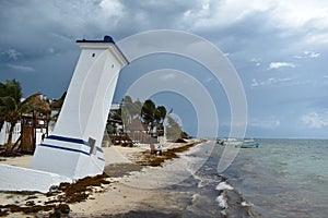 Tilted Faro Inclinado lighthouse in Puerto Morelos at the Malecon wooden pier on the Yucatan Peninsula in Mexico photo