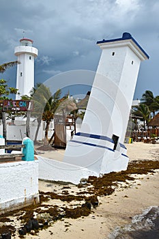 Tilted Faro Inclinado lighthouse in Puerto Morelos at the Malecon wooden pier on the Yucatan Peninsula in Mexico photo