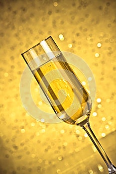 Tilted flute of golden champagne