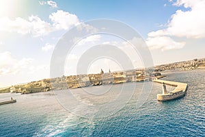 Tilted horizon view of La Valletta before sunset from the sea