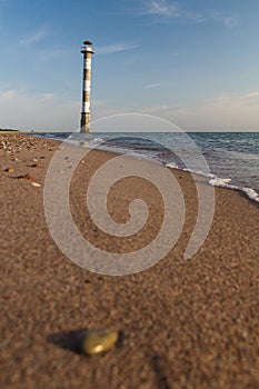 Tilted Kiipsaare lighthouse from beach surface view