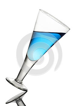 Tilted Wine Glass With Blue Drink on White Background