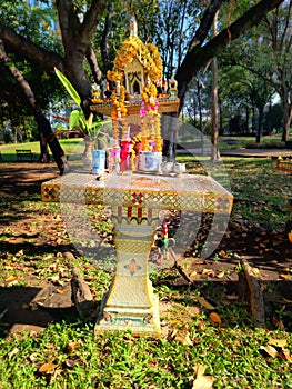 A tilting spirit house with a slanting platform.