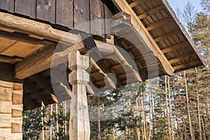 Timber construction of wall frame finish with burned planks on log house attic in sunlight