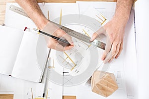 Timber craftsman drawing drafts at workplace