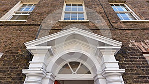 Timber Door Pediment against Red Brick Georgian Building