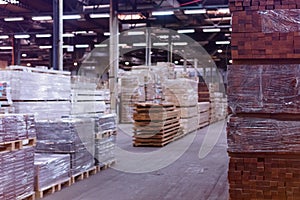 Timber Flooring Factory. Pile of cut wood in factory storage warehouse. Lumber in warehouse