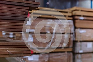 Timber Flooring Factory. Pile of cut wood in factory storage warehouse. Lumber in warehouse