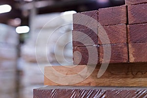 Timber Flooring Factory. Pile of cut wood in factory storage warehouse. Lumber in warehouse