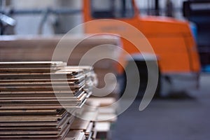 Timber Flooring Factory. Pile of cut wood in factory storage warehouse. Lumber in warehouse