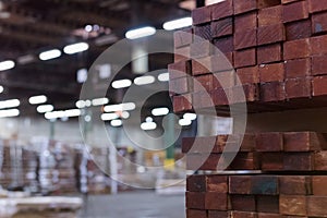 Timber Flooring Factory. Pile of cut wood in factory storage warehouse. Lumber in warehouse