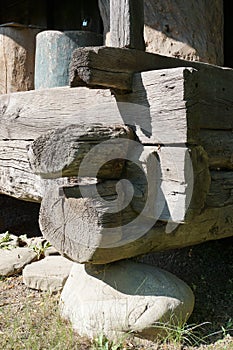 Timber footing beams placed on stone supports, corner detail to rural house