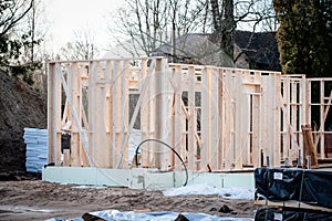 Timber frame building. Building structures on a construction site. Foundation insulation