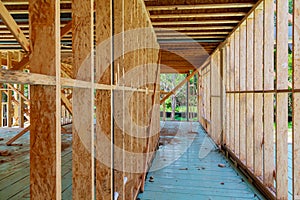 Timber frame house, stick built home under construction New build roof with wooden truss, post and beam framework.