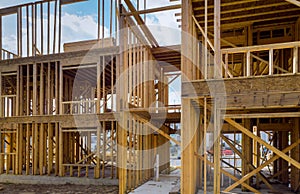 Timber frame house, stick built home under construction New build roof with wooden truss, post and beam framework.