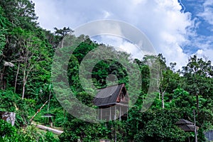 Timber house at Kathu waterfall water gently flowing down the rocks Patong Phuket Thailand Asia