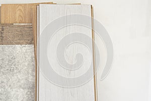 Timber, laminate flooring propped on white wall photo