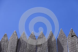 Timber pickets against blue sky