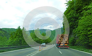 Timber transport logs on the mountain road