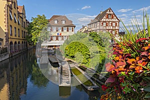 Timbered houses and canal with excursion boats in Little Venice, La Petite Venise, Colmar, Alsace, France.