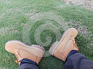 Timberland brand men& x27;s shoes on green grass. photo