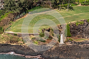 Timbers Kauai Ocean Golf Course and Kukii Point lighthouse, Nawiliwili, Kauai, Hawaii, USA