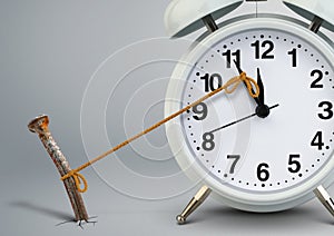 Time on alarm clock stop by nail, delay concept photo