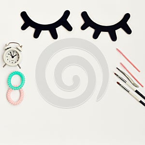 Time for beauty eyelashes and eyebrows: eyelash extension tools and decor on white background with copy space. top view. Flatley