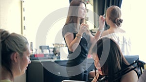 Time in a beauty salon. make-up artist and master of manicure. beautiful girls