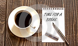 TIME FOR A BREAK - white paper with pen and coffee on wooden background