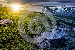 Time change concept. meadow with huge stones on top of mountain