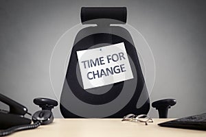 Time for change empty business chair with sign in office